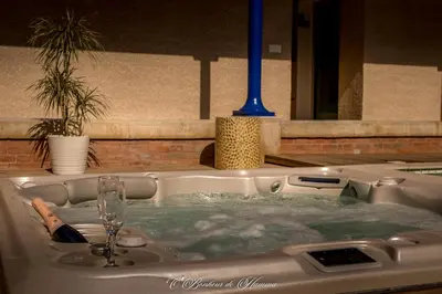 a bath tub filled with water with a sink at O'Bonheur de Hamma in Castelnaudary