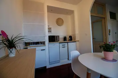 a kitchen with a table and a white counter top at O'Bonheur de Hamma in Castelnaudary