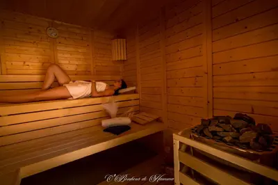a woman is laying in a sauna at O'Bonheur de Hamma in Castelnaudary