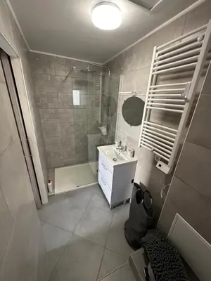 a bathroom with a shower and a sink and a mirror at CHEZ COCO ET HERVE rez-de-chaussée in Sigean