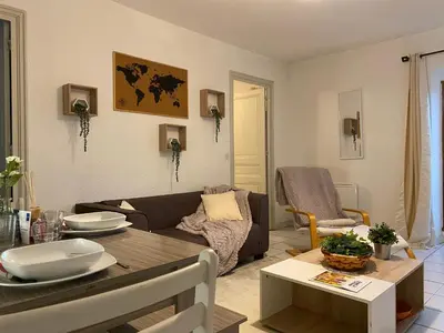 a living room with a couch and a table at Au pied de la cité, T3 au calme in Carcassonne