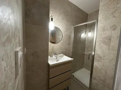 a bathroom with a sink and a shower and a mirror at Villa Mars YourHostHelper in Narbonne