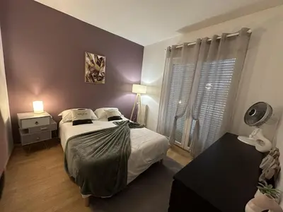 a bedroom with a large bed and a window at Villa Mars YourHostHelper in Narbonne