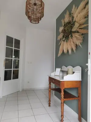 a room with a table and a flower painting on the wall at La Maison du Bagas, 7pers in Vielmur-sur-Agout