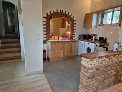 a kitchen with a counter and a brick wall at Mas de la vigne in Montredon