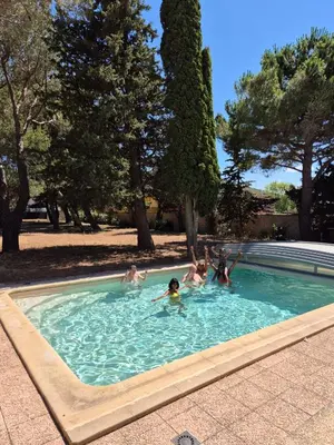 a group of people playing in a swimming pool at Mas de la vigne in Montredon