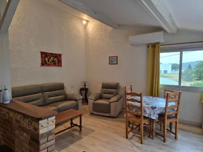 a living room with a couch and a table at Mas de la vigne in Montredon