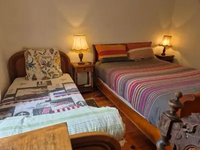 a bedroom with two beds and two lamps on tables at Mas de la vigne in Montredon