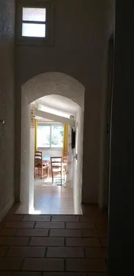 an archway in a room with a table and chairs at Mas de la vigne in Montredon