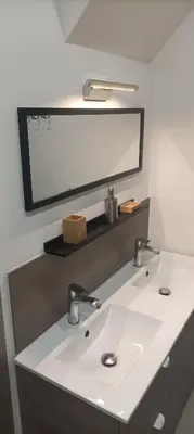 a bathroom with a white sink and a mirror at Grand T3 calme et lumineux 4-6 personnes in Moux