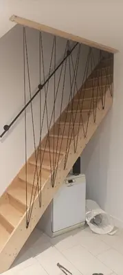 a wooden staircase with metal railings in a room at Grand T3 calme et lumineux 4-6 personnes in Moux