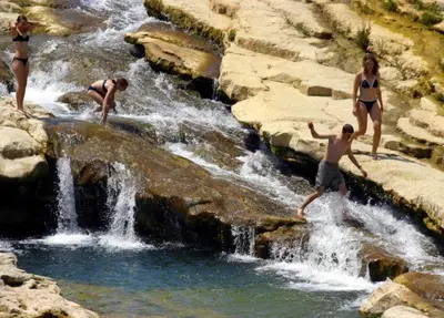a group of people in bathing suits jumping into a waterfall at Grand T3 calme et lumineux 4-6 personnes in Moux