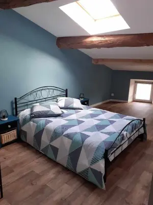 a bedroom with a large bed with a ceiling at Grand T3 calme et lumineux 4-6 personnes in Moux