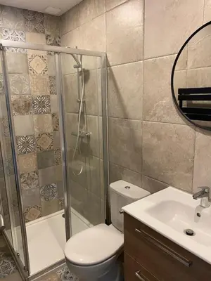 a bathroom with a shower and a toilet and a sink at Cosy T3 dans corps de ferme l écureuil in Vieillevigne