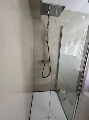 a shower with a glass door in a bathroom at Plumes Résidence de l’Agout in Castres