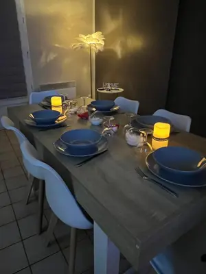 a dining table with blue plates and dishes on it at Plumes Résidence de l’Agout in Castres