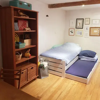 a bedroom with a bed and a book shelf at Petite maison de designer (avec terrasse) in Durban-Corbières
