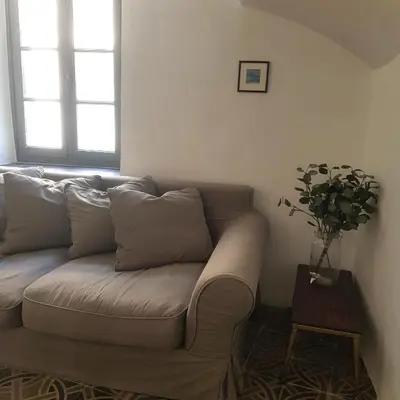 a couch sitting in a living room with a table at Petite maison de designer (avec terrasse) in Durban-Corbières