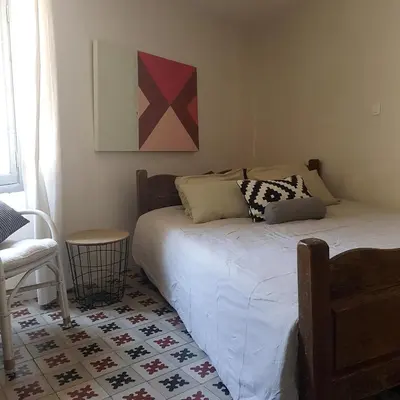 a bedroom with a bed and a table and a chair at Petite maison de designer (avec terrasse) in Durban-Corbières