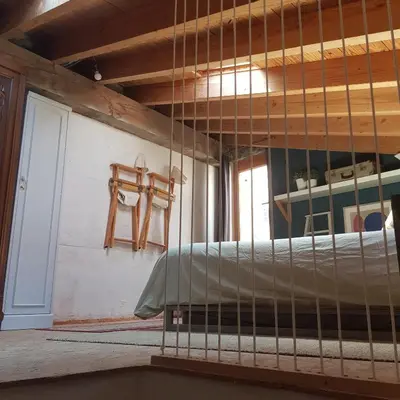 a bed in a room with a wooden ceiling at Petite maison de designer (avec terrasse) in Durban-Corbières