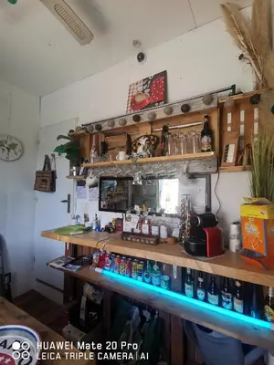 a bar in a room with a counter with drinks at L'ÉTAPE BIEN ÊTRE,chambres et tables d'hôtes, salon de massage in Camps-sur-lʼAgly