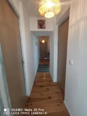 a hallway in a house with a chandelier at L'ÉTAPE BIEN ÊTRE,chambres et tables d'hôtes, salon de massage in Camps-sur-lʼAgly