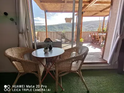 a white table and chairs on a porch with a view at L'ÉTAPE BIEN ÊTRE,chambres et tables d'hôtes, salon de massage in Camps-sur-lʼAgly