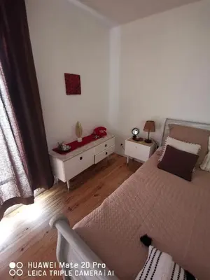 a bedroom with a bed and a table with two night stands at L'ÉTAPE BIEN ÊTRE,chambres et tables d'hôtes, salon de massage in Camps-sur-lʼAgly