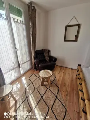 a living room with a couch and a table at L'ÉTAPE BIEN ÊTRE,chambres et tables d'hôtes, salon de massage in Camps-sur-lʼAgly