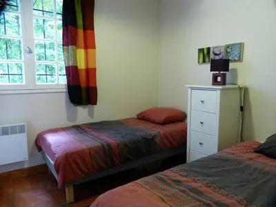 a bedroom with two beds and a window at Chalet with garden in the Pyrenees in Roquefort-de-Sault