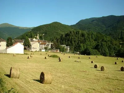 a field full of hay bales in a field at Chalet with garden in the Pyrenees in Roquefort-de-Sault