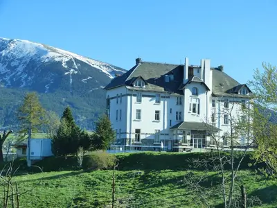 a large white house on a hill with a mountain at Chalet with garden in the Pyrenees in Roquefort-de-Sault