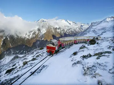 a train on the tracks on a snow covered mountain at Chalet with garden in the Pyrenees in Roquefort-de-Sault