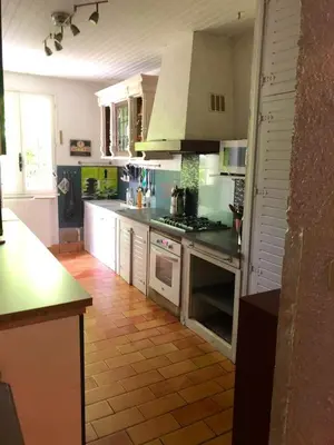 a kitchen with white appliances and a tile floor at Maison chaleureuse à Cuxac-Cabardès avec jardin de 3500m² in Cuxac-Cabardès