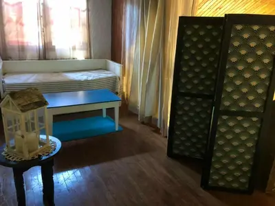a room with a bed and a table and a chair at Maison chaleureuse à Cuxac-Cabardès avec jardin de 3500m² in Cuxac-Cabardès