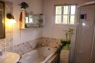 a bathroom with a sink and a tub and a toilet at Maison chaleureuse à Cuxac-Cabardès avec jardin de 3500m² in Cuxac-Cabardès