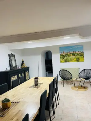 a dining room with a large wooden table and chairs at Domaine de Gourgounet gîte à la ferme, Gite de groupe 25 couchages avec piscine privative in Villefloure