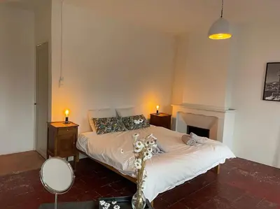 a bedroom with a bed and two lamps and a fireplace at The Forge Esperaza in Espéraza