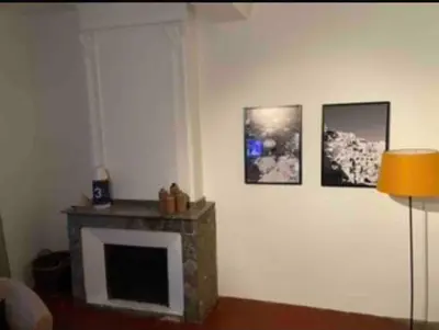 a living room with a fireplace and pictures on the wall at The Forge Esperaza in Espéraza