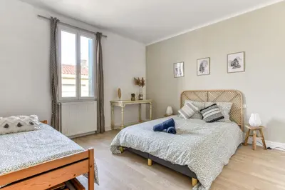 a bedroom with two beds and a window at La Casa Grande - piscine - wifi - parking in Carcassonne