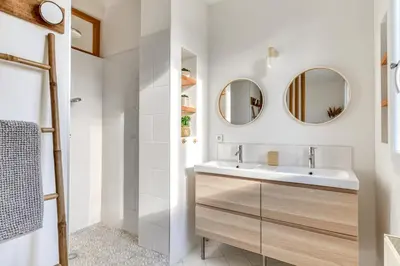 a bathroom with a sink and two mirrors at La Casa Grande - piscine - wifi - parking in Carcassonne