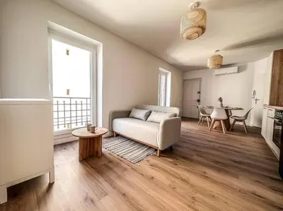 a living room with a couch and a table at T2 Le Miredames in Castres