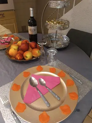 a plate with two spoons and a napkin on a table at Jolie maison de village in Capendu