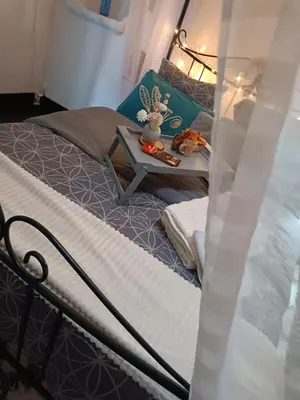 a bedroom with a bed with a table on it at Jolie maison de village in Capendu