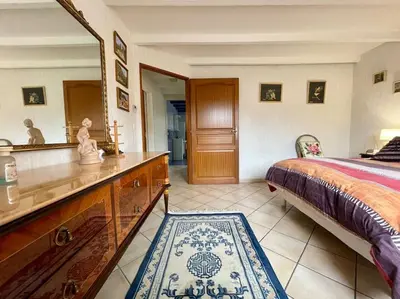 a bedroom with a bed and a dresser and a mirror at Villa Anatole - parking privé - 900m Cité Médiévale in Carcassonne