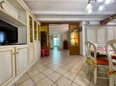 a hallway of a house with a painting on the wall at Villa Anatole - parking privé - 900m Cité Médiévale in Carcassonne
