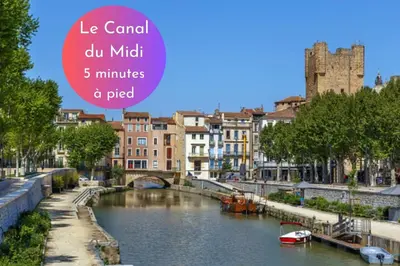 a view of a river in a city with buildings at Cachette Secrète & SPA Narbonne in Narbonne