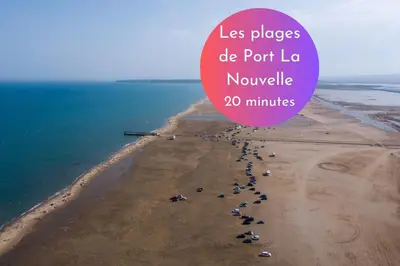 a beach with a bunch of umbrellas on it at Cachette Secrète & SPA Narbonne in Narbonne