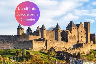 a castle on a hill with the words la cite de casserole minutes at Cachette Secrète & SPA Narbonne in Narbonne