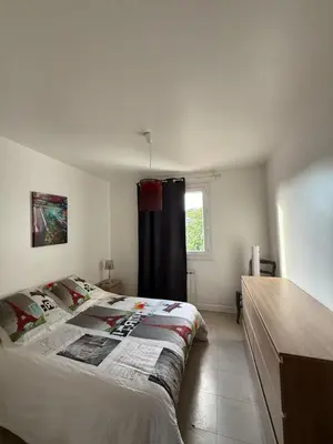 a bedroom with a large bed and a window at escapade près du lac in Peyriac-de-Mer